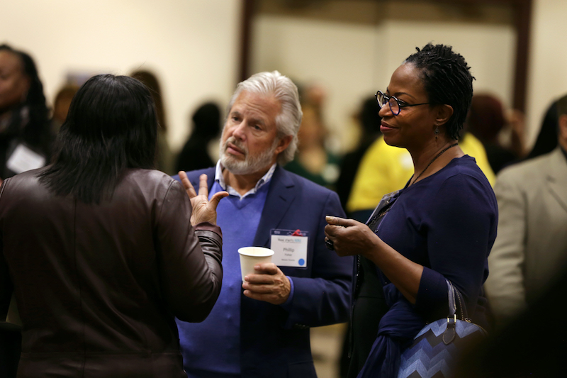 women talking to man and woman at a seminar