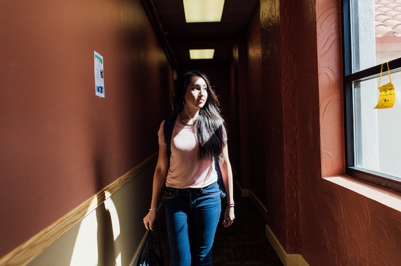 NM Video women walking down a sun lit hallway