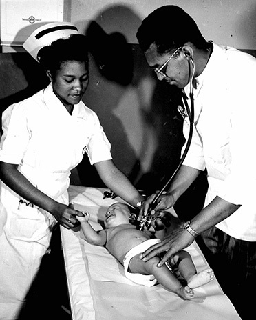 HBCUNurseAndDoctorExaminingBabyMay101948PH173MeharryMedicalCollege HBCUNurseAndDoctorExaminingBabyMay101948PH173MeharryMedicalCollege