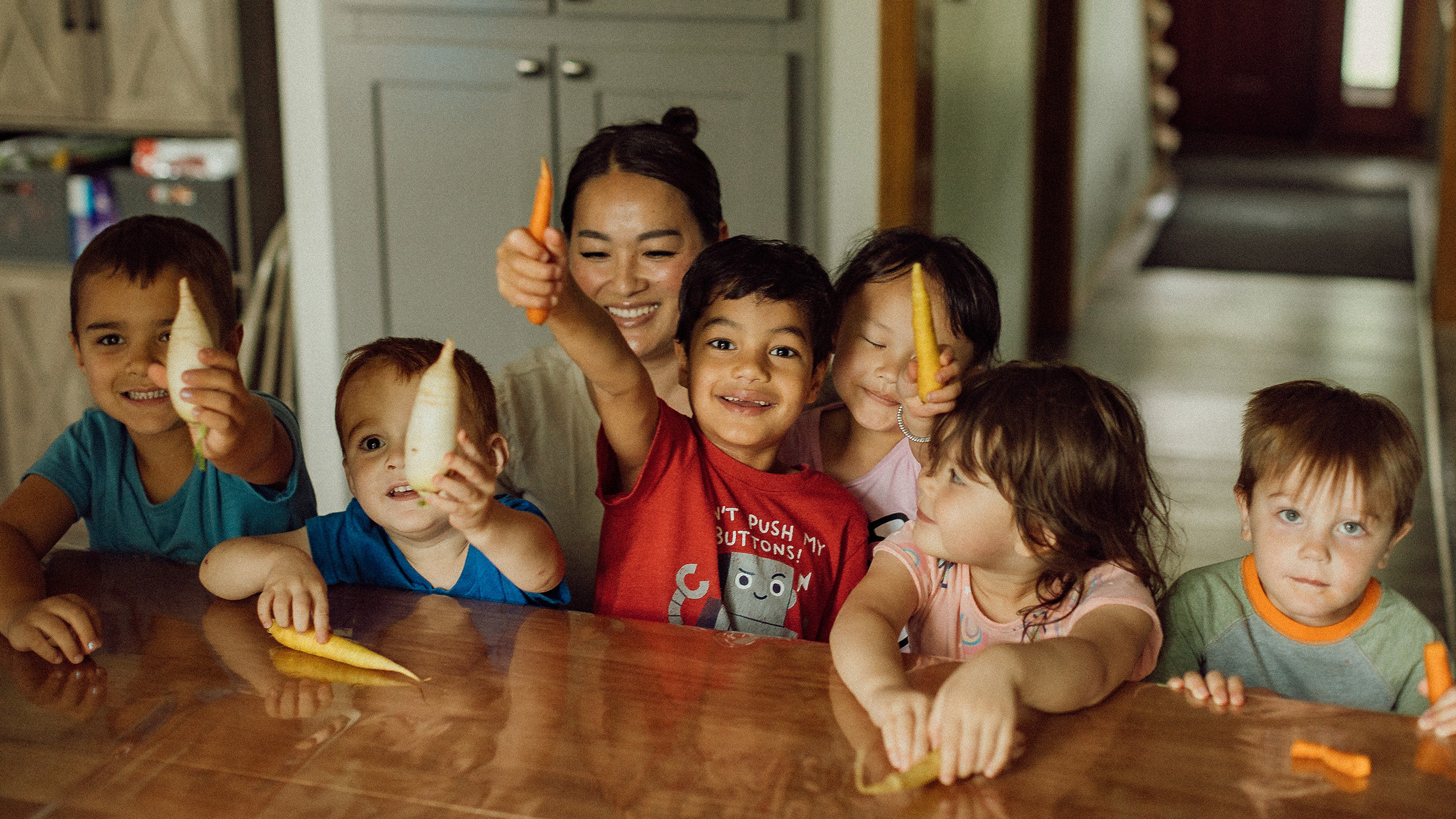 Children smiling at a table | W.K. Kellogg Foundation