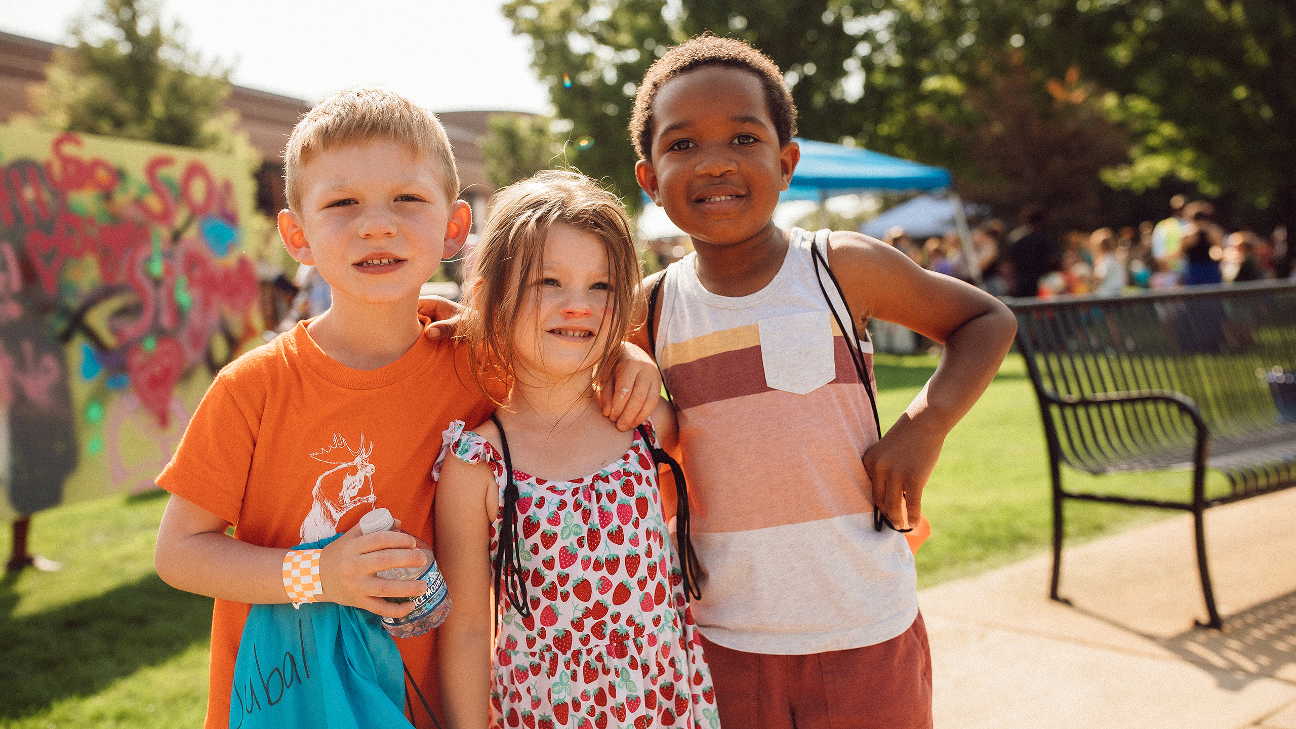 Group of three children outside